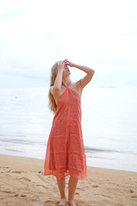 Model wearing the Mimi burnt orange halter dress, highlighting its versatility and flattering fit for any occasion.