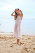 Load image into Gallery viewer, Model wearing the Mimi light pink floral halter dress, exuding a chic and feminine vibe for any casual outing.