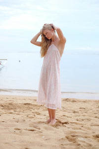Model wearing the Mimi light pink floral halter dress, exuding a chic and feminine vibe for any casual outing.