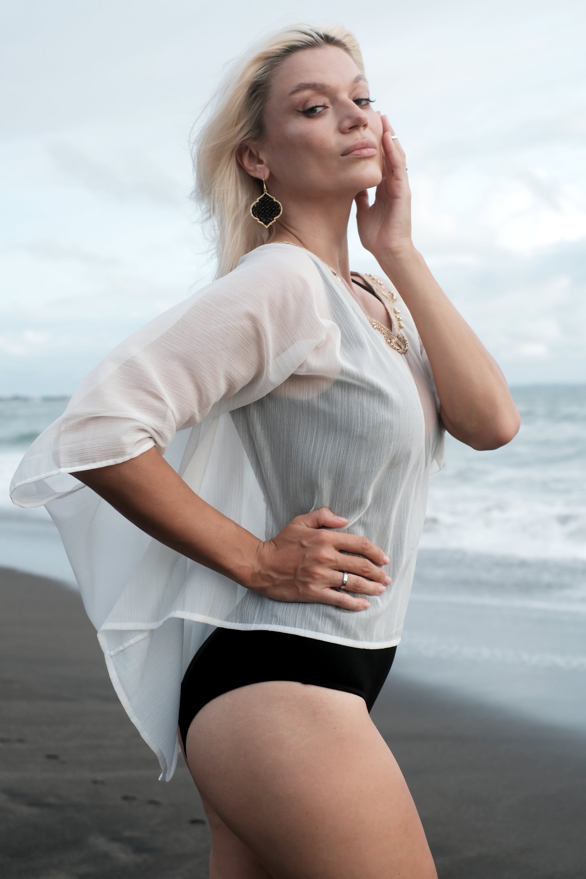Lightweight white beach kaftan cover-up with V-neck and gold embellishment, perfect for beach clubs & resort evenings out in Dubai.

