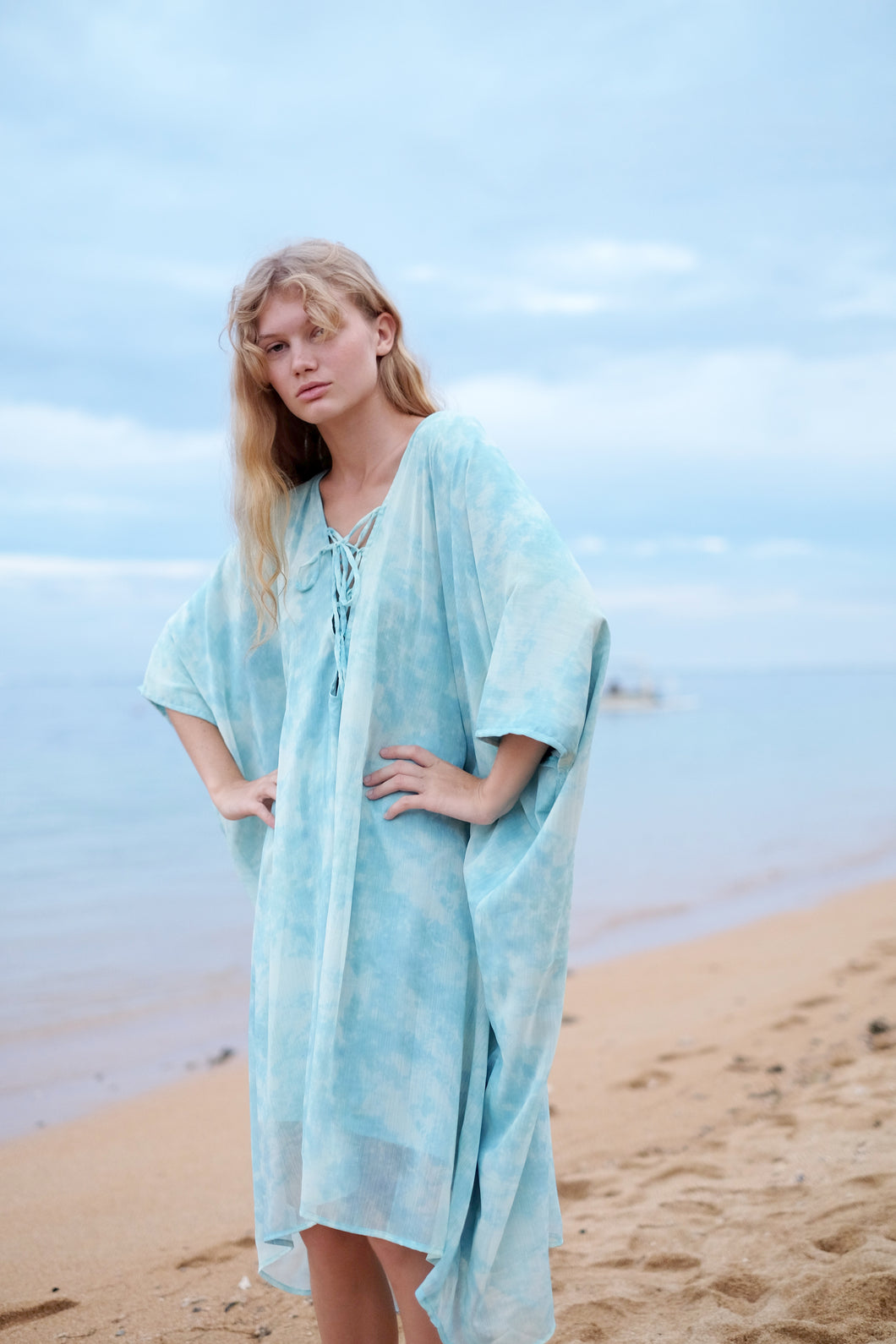 Luxurious sky blue marble chiffon Seraphina kaftan dress for elegant beach style.
