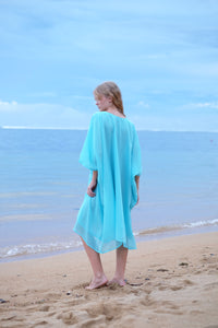 Back view of Seraphina aquamarine multiway kaftan dress made from lurex crepe chiffon with a hint of shimmer, for a glamorous beach look for women in Dubai 