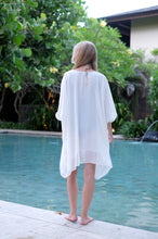 Load image into Gallery viewer, Back view of the Seraphina multiway kaftan, transformed into a halter dress, highlighting its stylish versatility, perfect for fashionable women in Dubai, sustainably made in Bali
