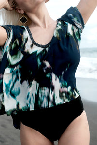 Close up of Shira navy abstract print beach kaftan top with hand-sewn blue beads on its neckline for women in Dubai