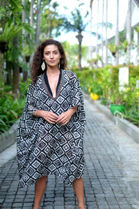 Full-length view of the Ameyo kaftan, showcasing a bold geometric print and hand-sewn metallic details for women's resort fashion.