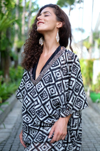 Close up view of the Ameyo kaftan, showcasing a bold geometric print and hand-sewn metallic details for women's resort fashion, sustainably made in Bali for women in Dubai