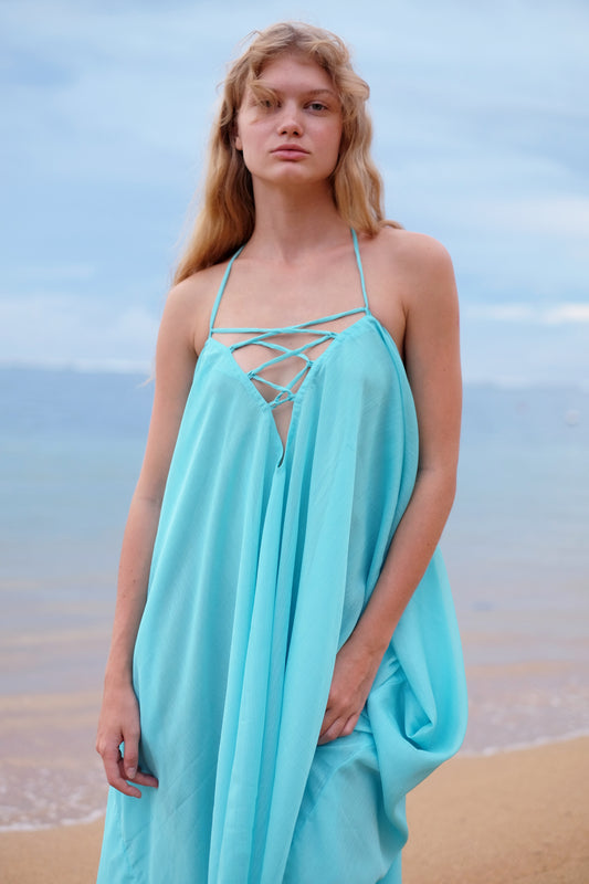 Aquamarine Seraphina Kaftan Dress with shimmering crepe chiffon, styled as a halter dress, perfect for Dubai beaches and resort wear. Sustainable fashion made in Bali.
