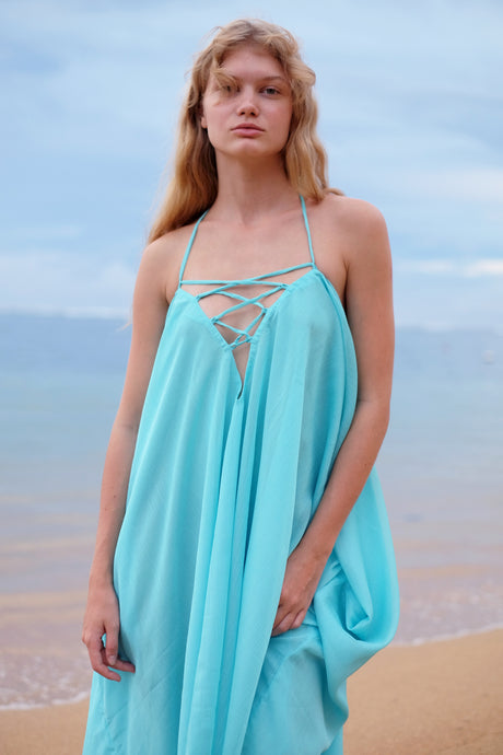 Aquamarine Seraphina Kaftan Dress with shimmering crepe chiffon, styled as a halter dress, perfect for Dubai beaches and resort wear. Sustainable fashion made in Bali.
