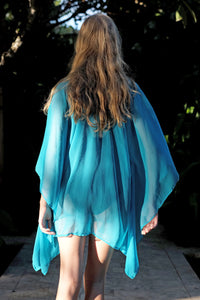 Luxurious swimsuit cover-up in turquoise chiffon with gold trim, handmade and sustainable resort wear from Bali for women looking where to buy kaftans in Dubai
