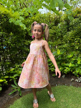 Load image into Gallery viewer, Girls’ Floral Summer Dress in Hand-Stamped Batik with adjustable shoulder straps and waist – Sustainable Dubai Resort Wear for kids
