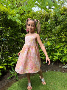 Girls’ Floral Summer Dress in Hand-Stamped Batik with adjustable shoulder straps and waist – Sustainable Dubai Resort Wear for kids
