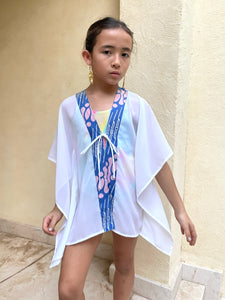 Girls' beach cover-up in white lurex chiffon with handcrafted parang batik trim, stylish and breathable resort wear.
