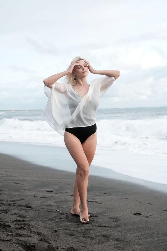 White beach kaftan with gold trim for women, sustainably made resort-style beach cover-up ideal for Dubai holidays.

