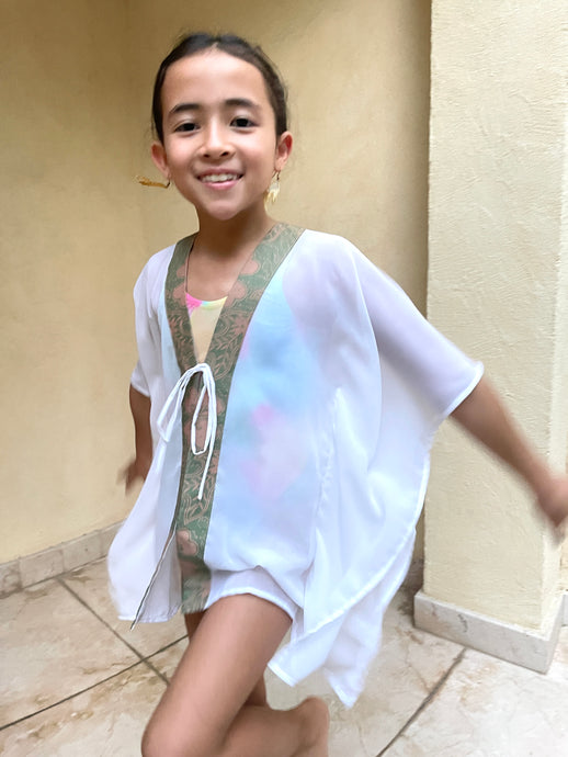 Handmade Onism kids kaftan with white lurex chiffon and sage pink batik trim, perfect for Dubai beach resorts