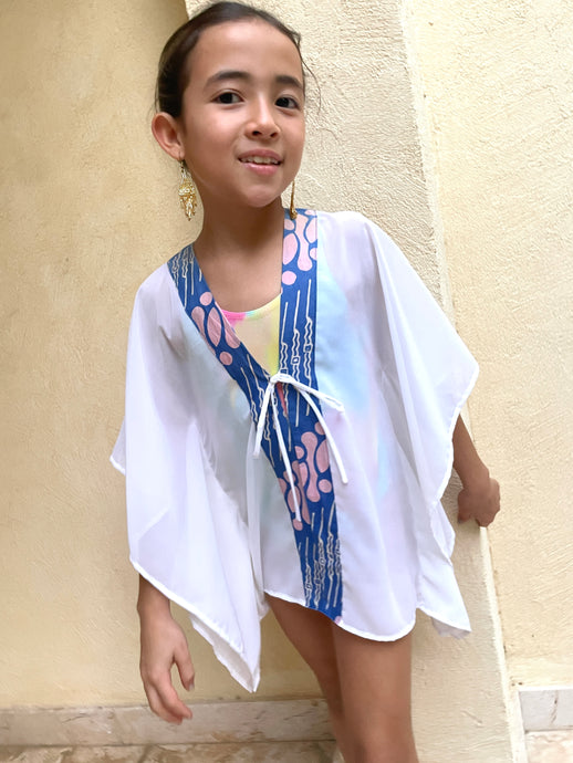 Handmade kids beach kaftan with pink and blue parang batik trim, lightweight chiffon cover-up for girls in Dubai.
