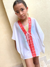 Load image into Gallery viewer, Handmade kids kaftan with vibrant orange floral batik trim, perfect for Dubai beach days