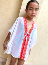 Load image into Gallery viewer, Girls&#39; beach kaftan with bright orange floral print and playful batik trim made in Bali, for sale in Dubai