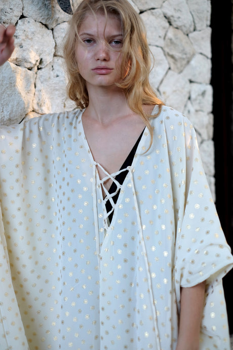 Elegant cream and gold Seraphina kaftan dress with shimmering gold motifs and versatile styling options for a chic resort look.