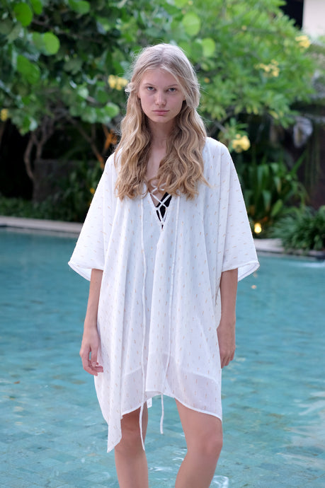 Seraphina kaftan dress in white with gold and silver-embellished chiffon, made in Bali for Dubai beach fashionistas.
