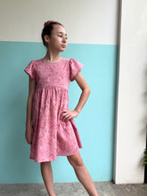Load image into Gallery viewer, Ethically made girls’ pink floral batik sundress with adjustable back tie, perfect for beach days and warm-weather outings in Dubai
