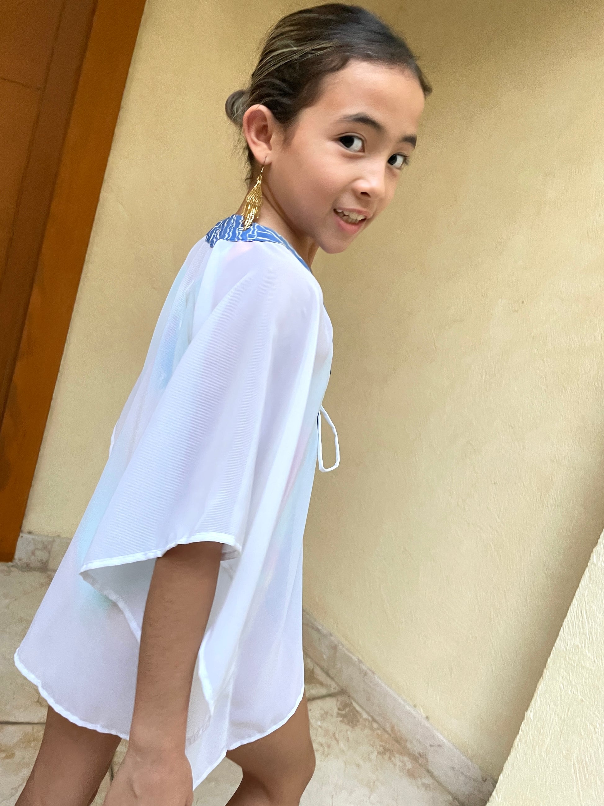 Sustainable kids beach kaftan with pink and blue parang batik design, handmade in Bali and available in Dubai.

