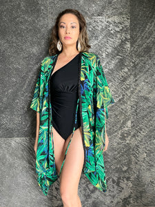 front view of green tropical palm beach kaftan with black beaded neckline, beachwear for dubai vacations, perfectly paired with handmade bead earrings also from Bali

