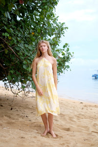 Feminine yellow floral halter neck dress, ideal for resort wear or casual outings  in Dubai, sustainably made in limited quantities in Bali
