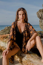 Load image into Gallery viewer, Black and gold women&#39;s beach kaftan cover up with hand sewn bronze bead neckline trim. Shop luxury beach cover ups in Dubai, perfect for beach clubs and resort vacations.
