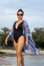 Load image into Gallery viewer, Sustainable resort wear from Bali, made for women in Dubai who love modern beachwear. The Sahila kaftan in a blue snake print, luxurious chiffon with metallic beads along the neckline.
