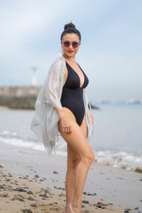 Lynx leopard print beach kaftan featuring hand-sewn beads along the neckline, sustainable resort wear made in Bali for glamorous women in Dubai looking for modern beachwear







