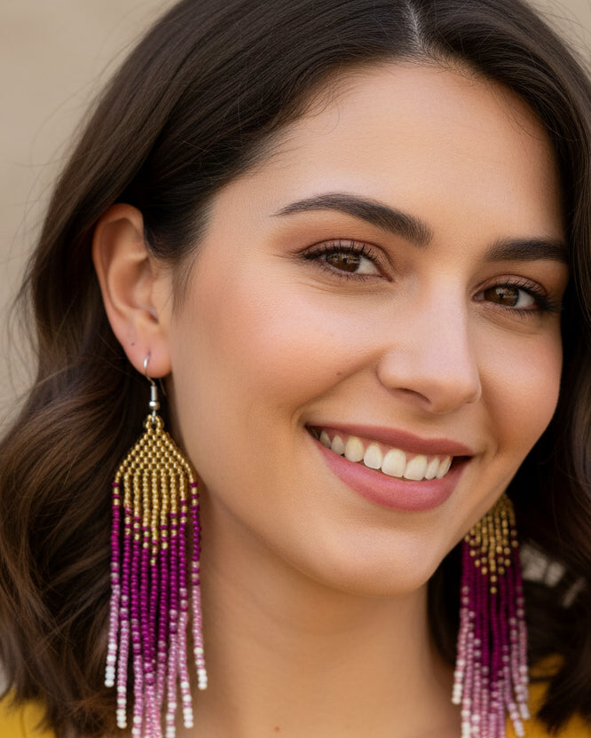 Close-up of a woman wearing colorful beaded earrings with a neutral background