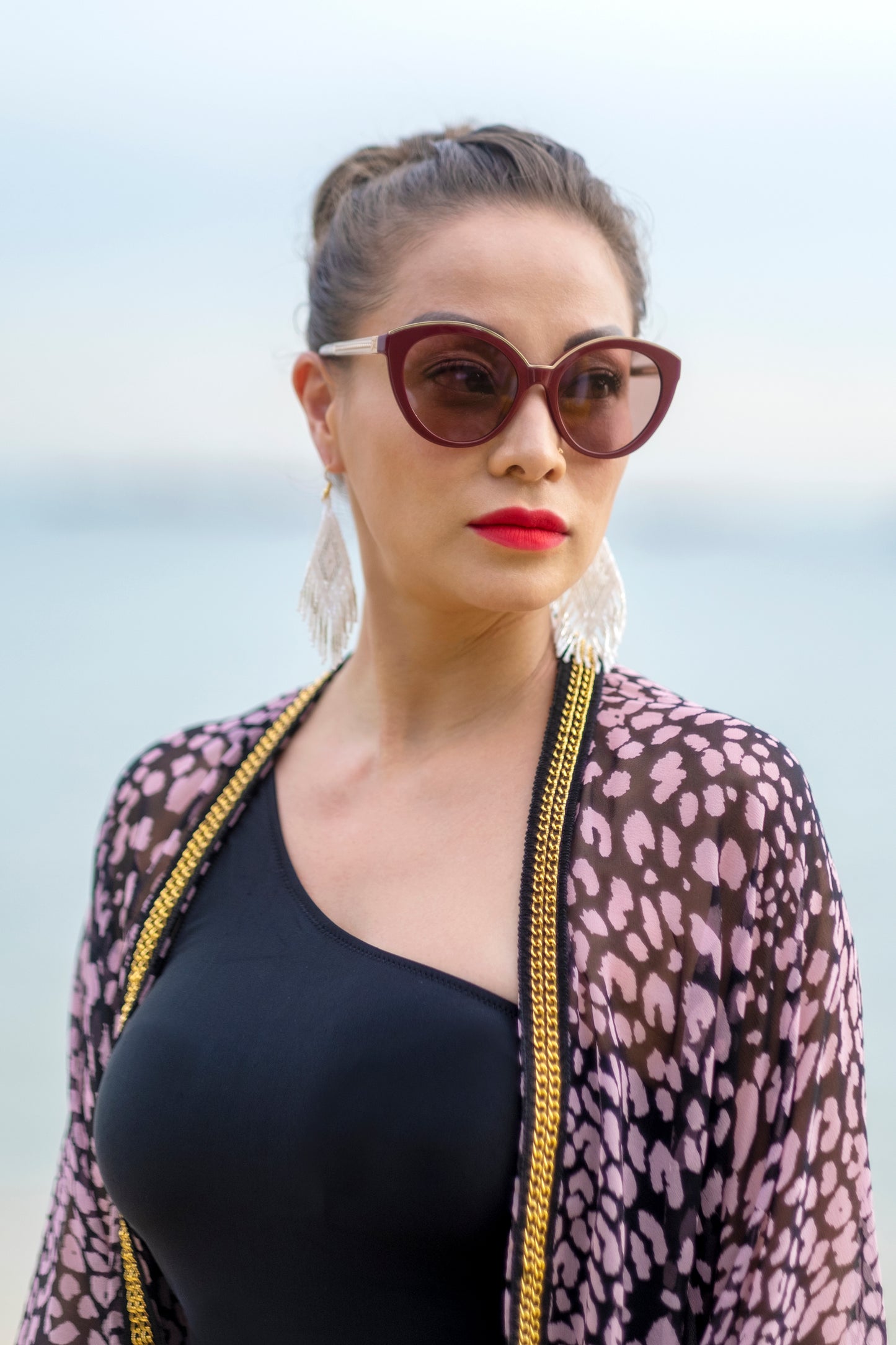 Close-up of gold chain trim on the Sacha leopard print kaftan made from silk chiffon, sustainable resort wear handmade in Bali for women and ladies in Dubai who love unique beachwear
