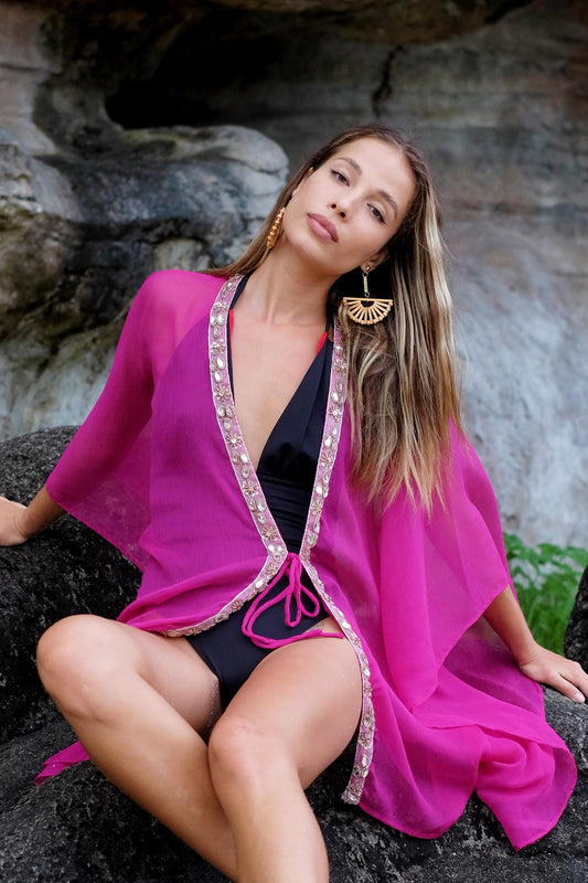 Statement resort kaftan with delicate crystal embellishments in a gorgeous fuchsia crepe chiffon flowy fabric, for women looking for unique and luxury beach kaftans in Dubai