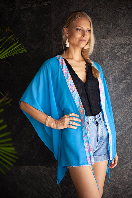 Utama ocean blue chiffon kaftan with artisan handmade batik trim – elegant beach cover-up for Dubai resort wear.
