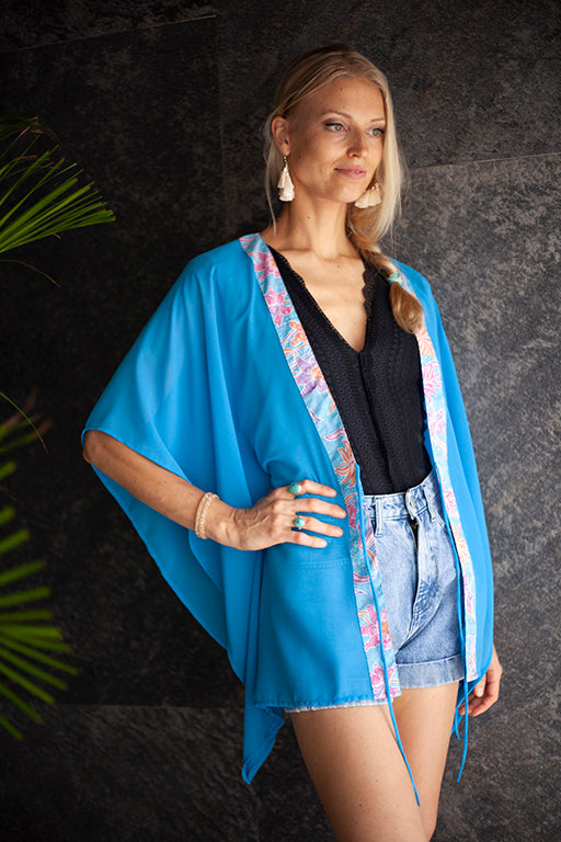 Utama ocean blue chiffon kaftan with artisan handmade batik trim – elegant beach cover-up for Dubai resort wear.
